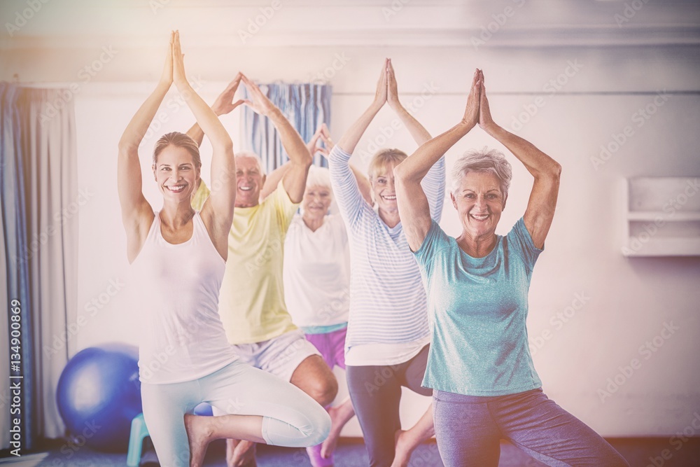 Instructor performing yoga with seniors