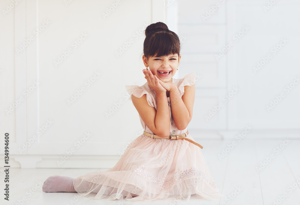 portrait of beautiful delighted little lady with cute toothless smile