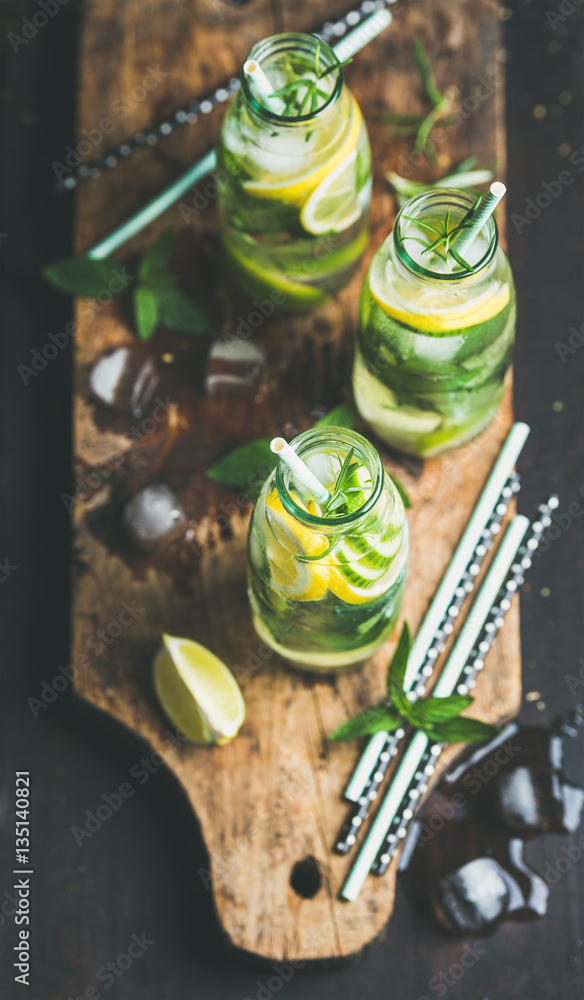 Citrus and herbs infused sassi water for detox, healthy eating, dieting in glass bottles with straws