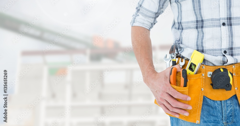 Handyman with hands on hip and tool belt