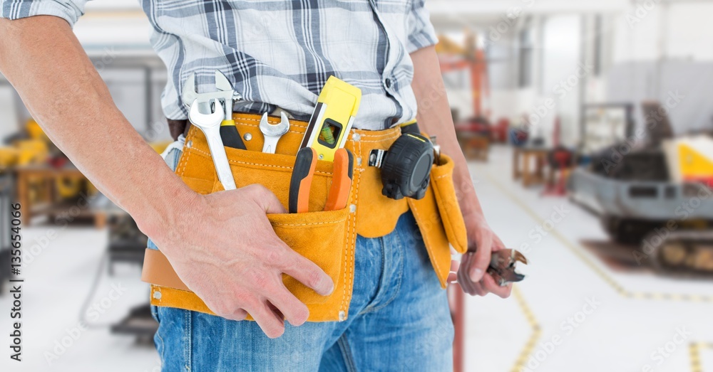 Handyman with tool belt at workshop