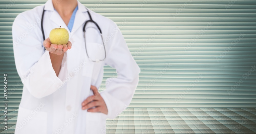 Doctor with stethoscope and holding apple
