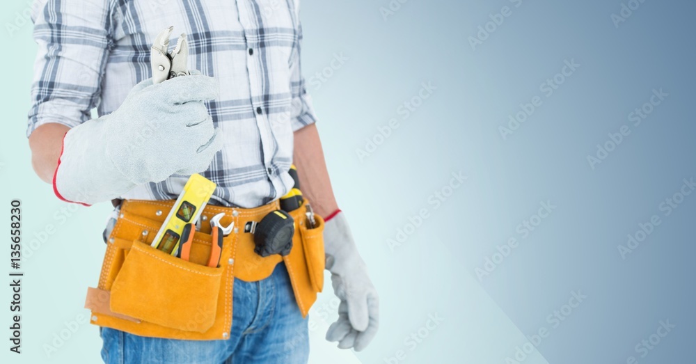 Mid section of handyman with tool belt and wrench