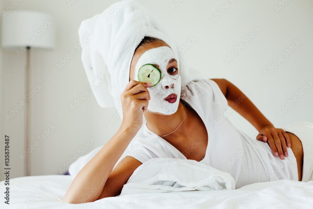 Teenage girl making facial mask