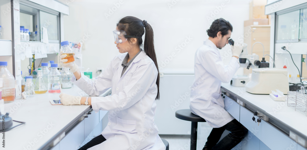 Asian scientist  in the laboratory working at lab with test tube