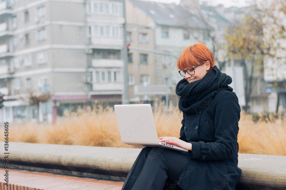 The girl with laptop on outdoor