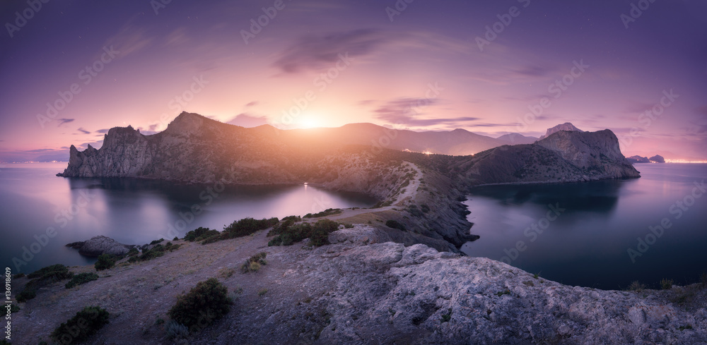 Beautiful mountains against colorful cloudy sky at sunset. Landscape with rocks, sea, mountain trail