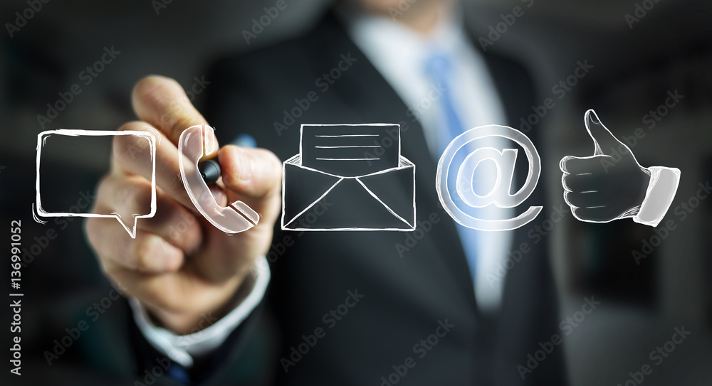 Businessman drawing manuscript contact icon with a pen