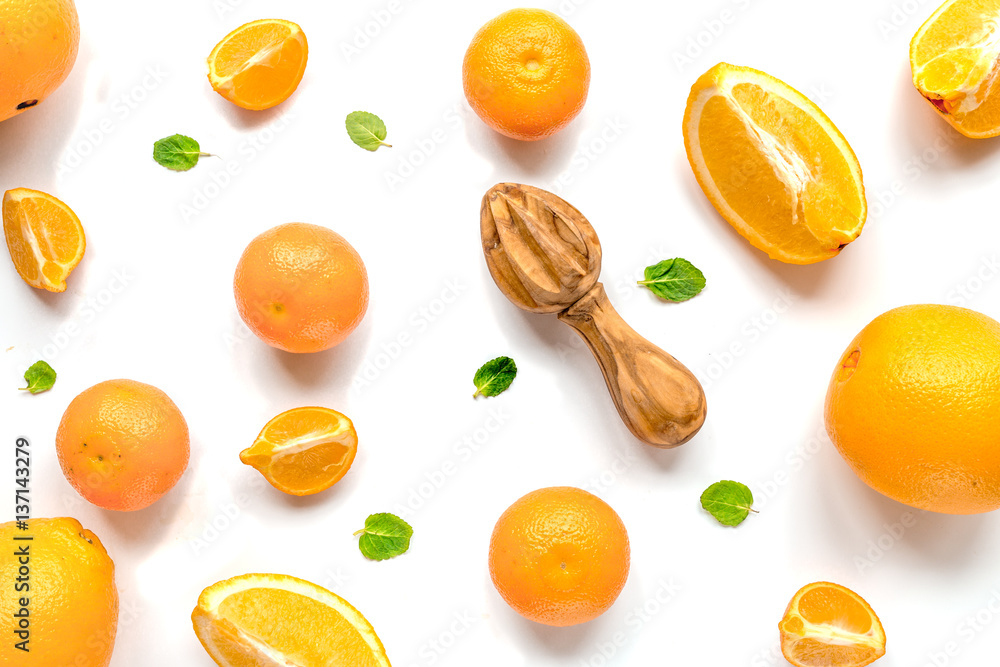 Cut oranges for juicy breakfast on white background top view pattern
