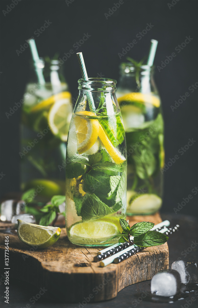 Citrus fruit and herbs infused sassi water for detox, healthy eating or dieting in glass bottles on 