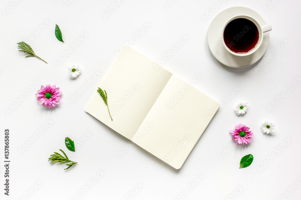 Notebook with cup of coffee on white background top view mockup