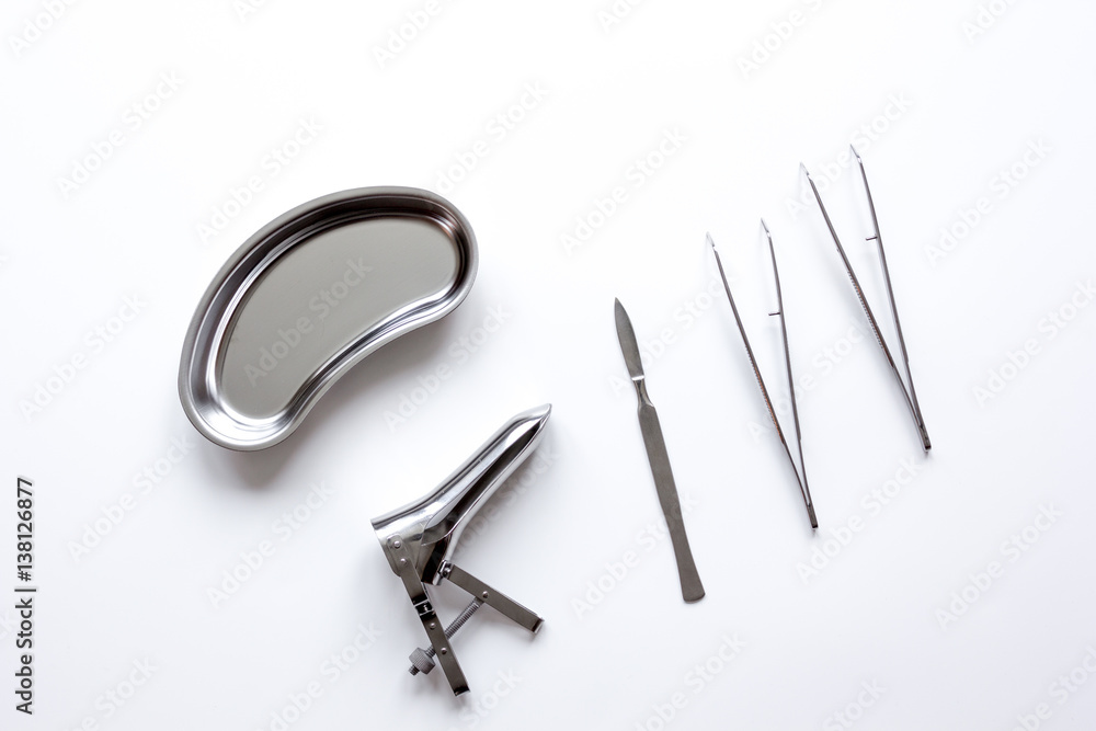 instruments of gynecologist on white background top view