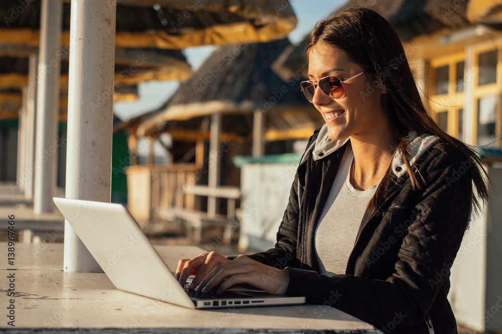 Girl with laptop working outdoor
