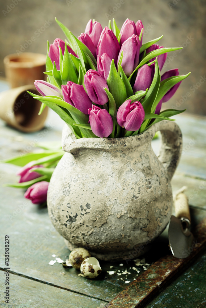 粉色郁金香花束、复活节彩蛋和园艺工具