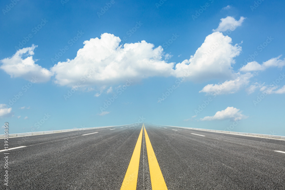 asphalt road under the blue sky
