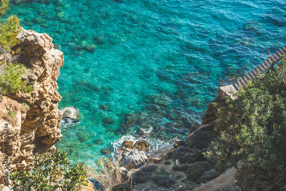 岩石上的楼梯，一直延伸到图尔南地中海海岸的泻湖和绿松石海水