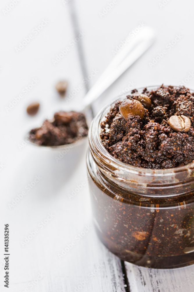 Body scrub of ground coffee on wooden table background