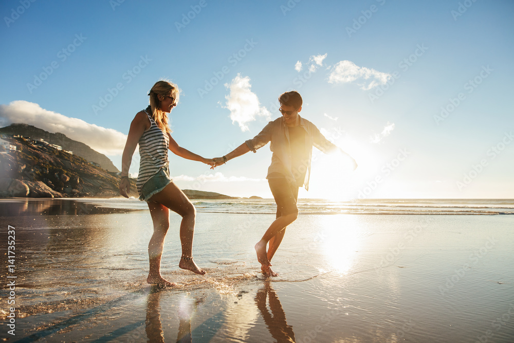 Young couple enjoying holidays on the sea shore