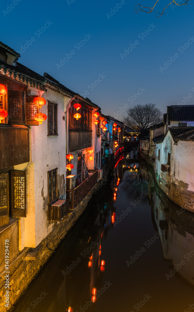 Traditional old riverside houses illuminated at night in Shantang water town, Suzhou, Jiangsu Provin