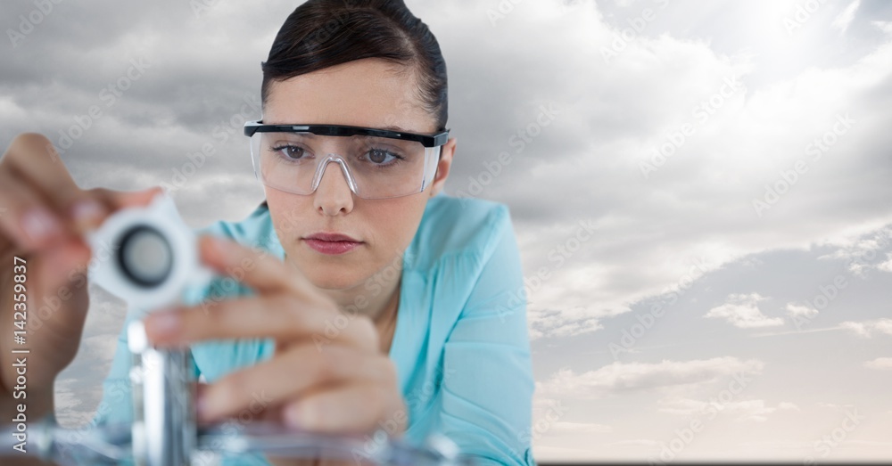 Close up of woman with electronics against sky