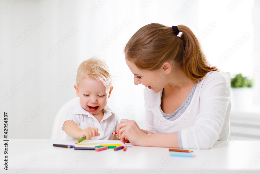 Mother with baby son with colored pencils
