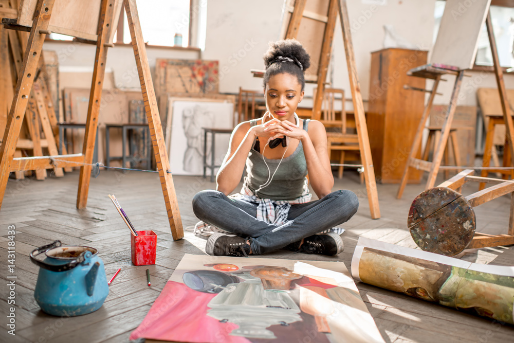 Portrait of a young african ethnicity student with still life painting at the university studio. Wom