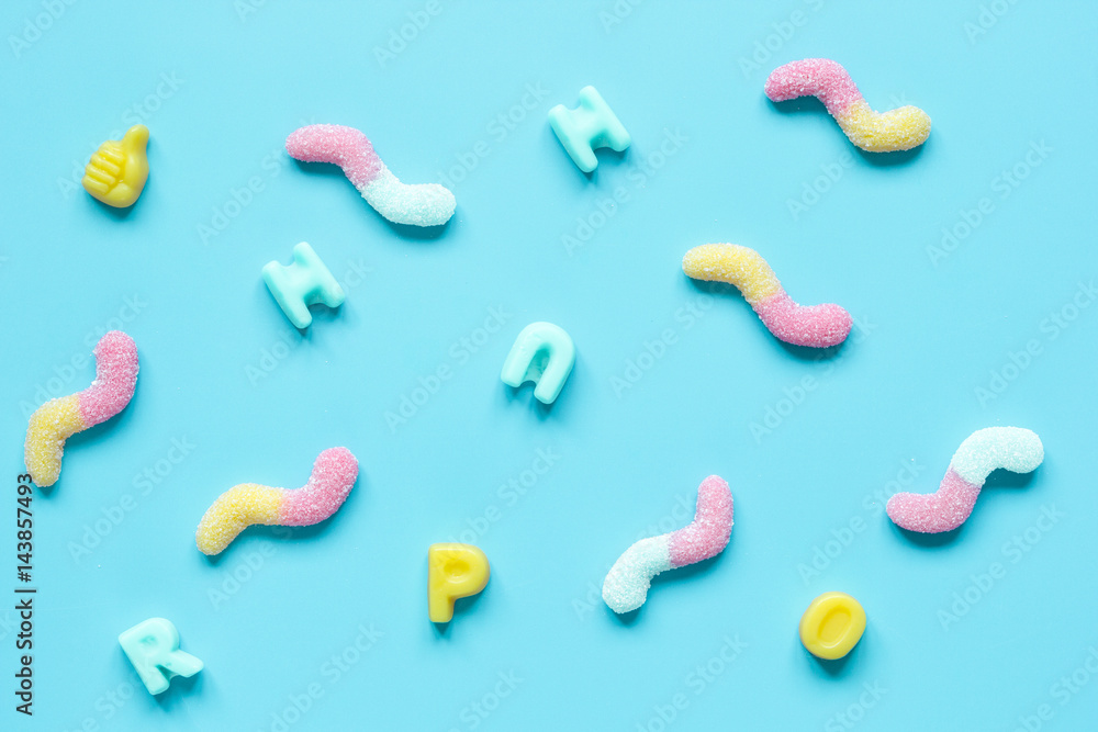 sweets and sugar candies on blue background top view pattern