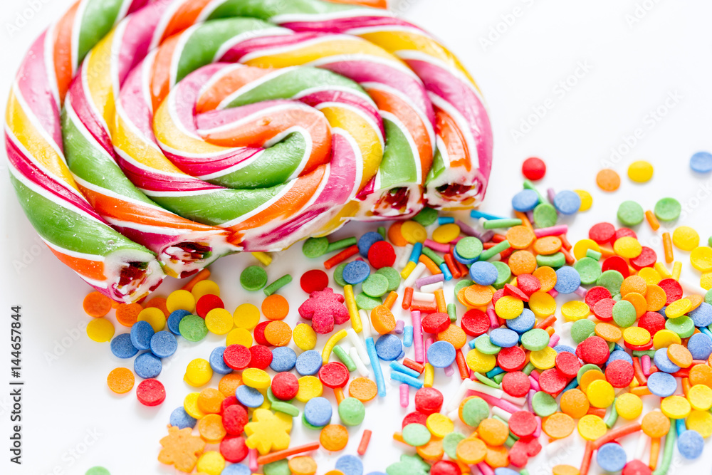 Delicious sugar lollipops on abstract candy background pattern