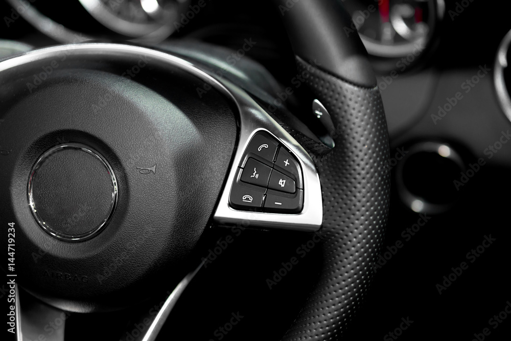 Close up of steering wheel commands in modern luxury car. Interior of car. Smart car.