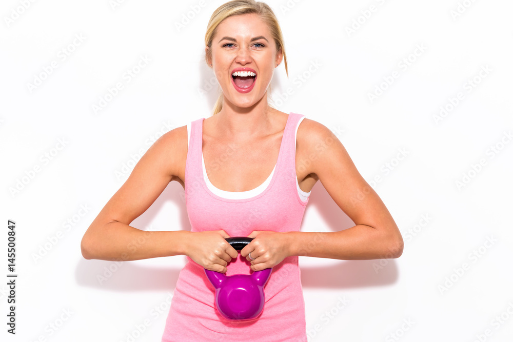 Happy woman working out with kettlebell