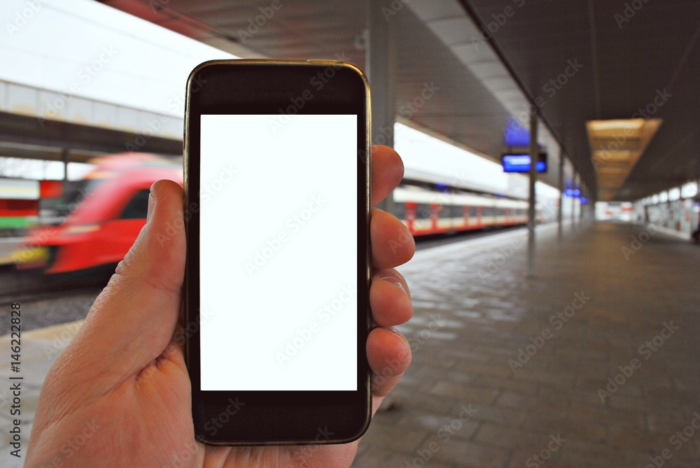 Hand holding smartphone with subway station background