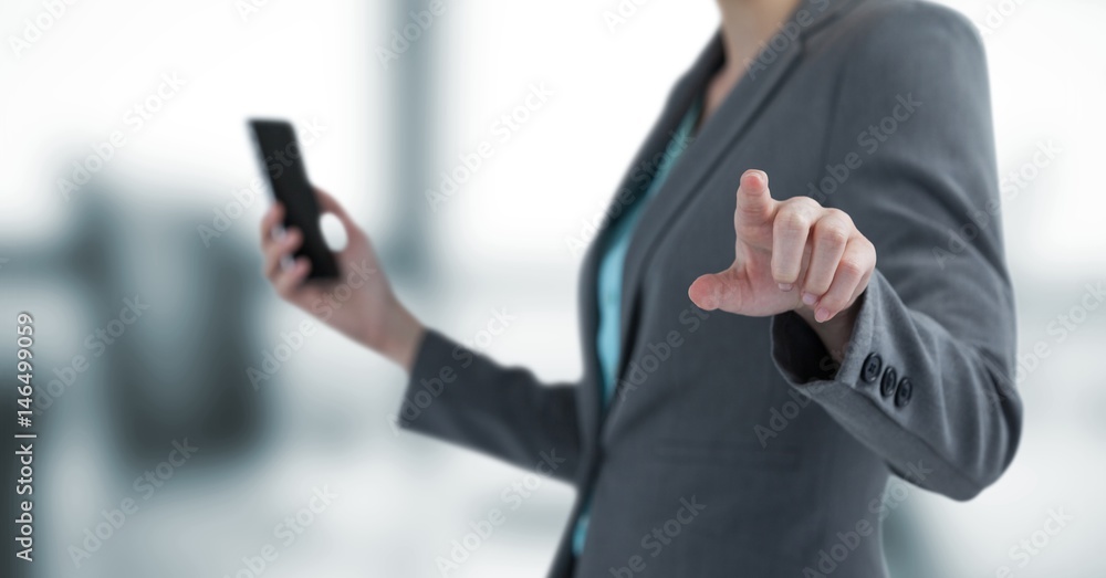 Midsection of businesswoman holding mobile 