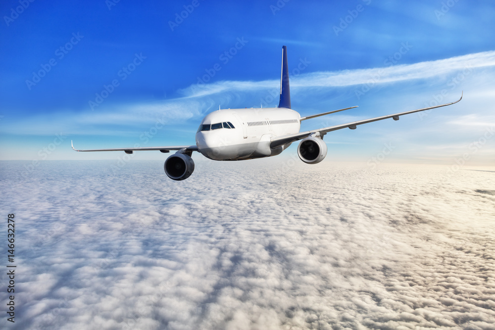 Passengers airplane flying above clouds