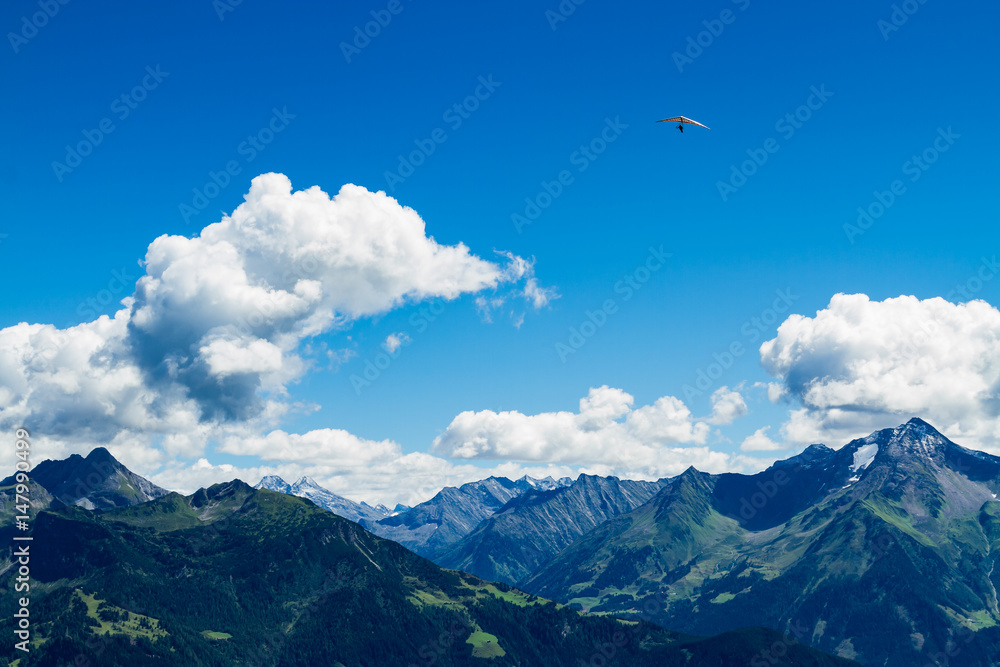 High mountains landscape with hang glider in soaring flight. Austria, Tirol, Zillertal