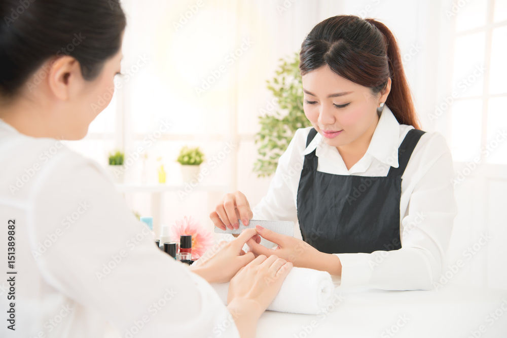 manicure in beauty salon nail filing close up