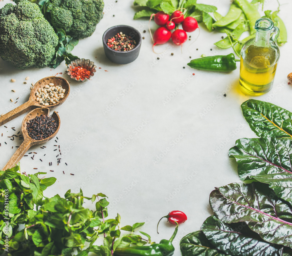 浅灰色大理石厨房台面上的新鲜生蔬菜、蔬菜、橄榄油和谷物，复制品
