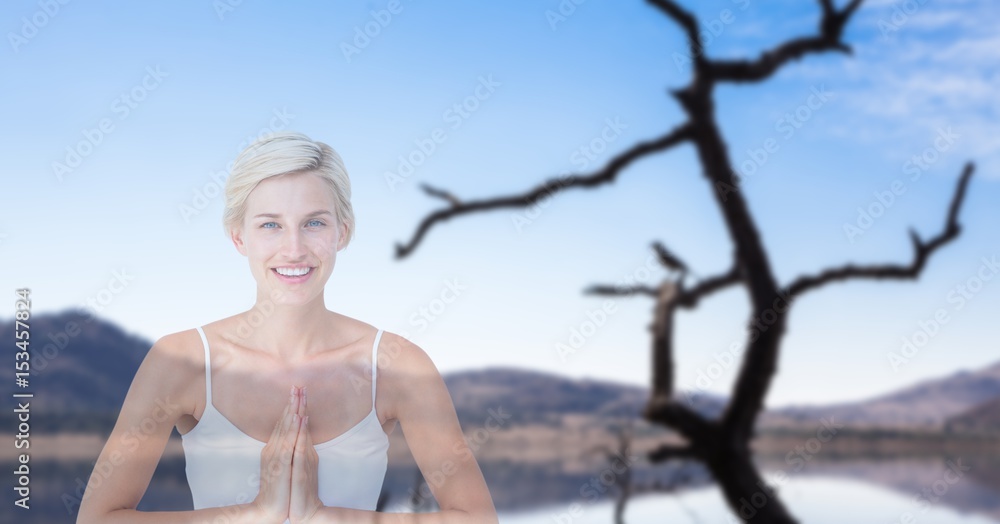 woman with hands clasped performing yoga