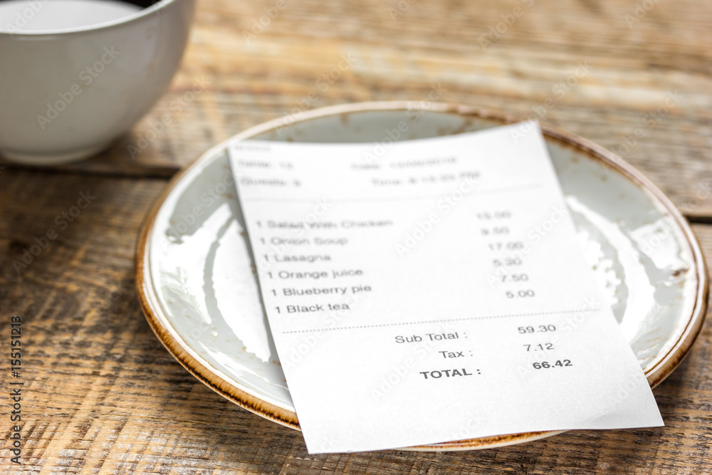 restaurant bill paying by credit card for coffee on wooden table background