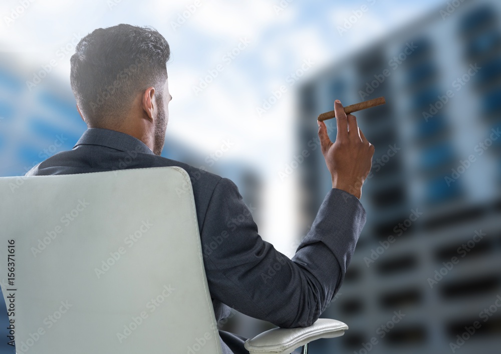 Businessman Back Sitting in Chair with cigar next to buildings
