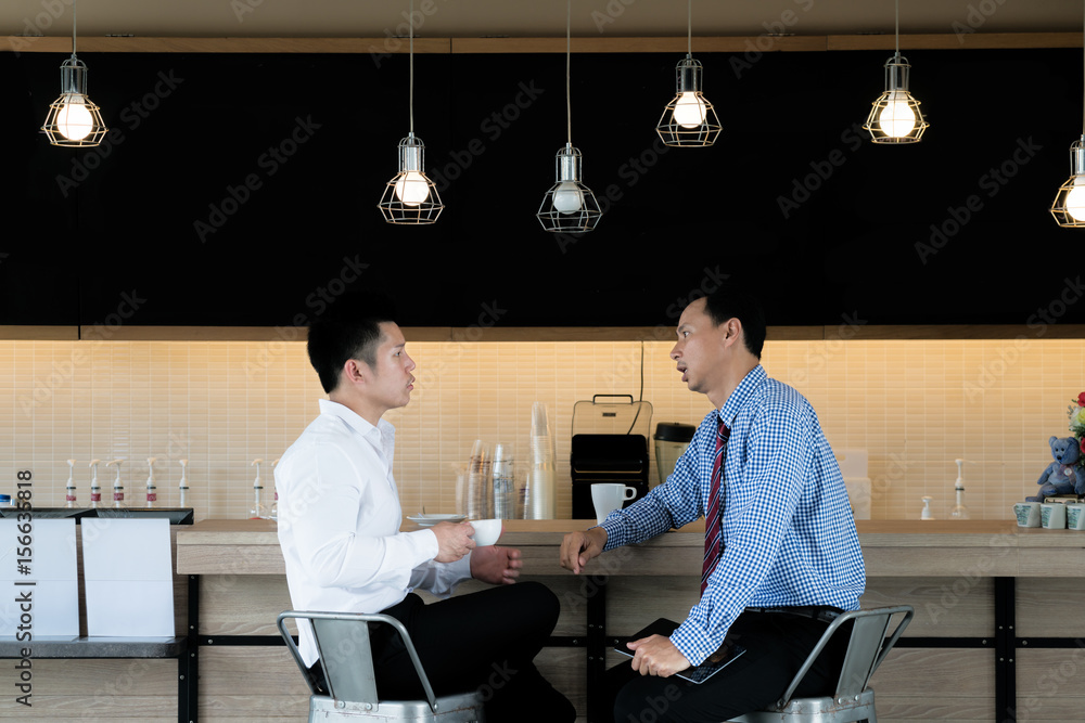 Portrait of casual two Asian business people meeting in cafe for talking and discussing during break