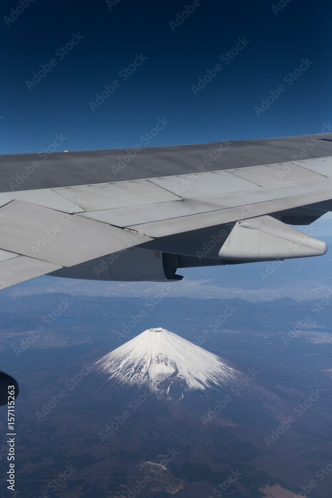 Top of Mountain Fuji with snow in winter season , taken from on airplane after takeoff from Tokyo Ha