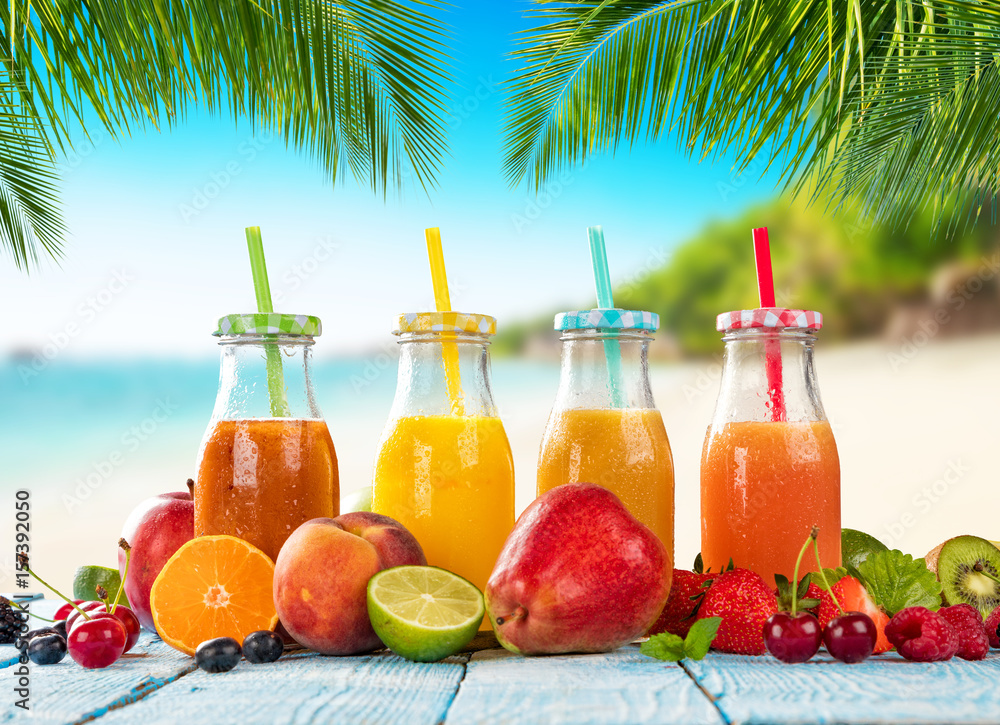 Fresh smoothie drinks placed on wooden planks, blur beach on background