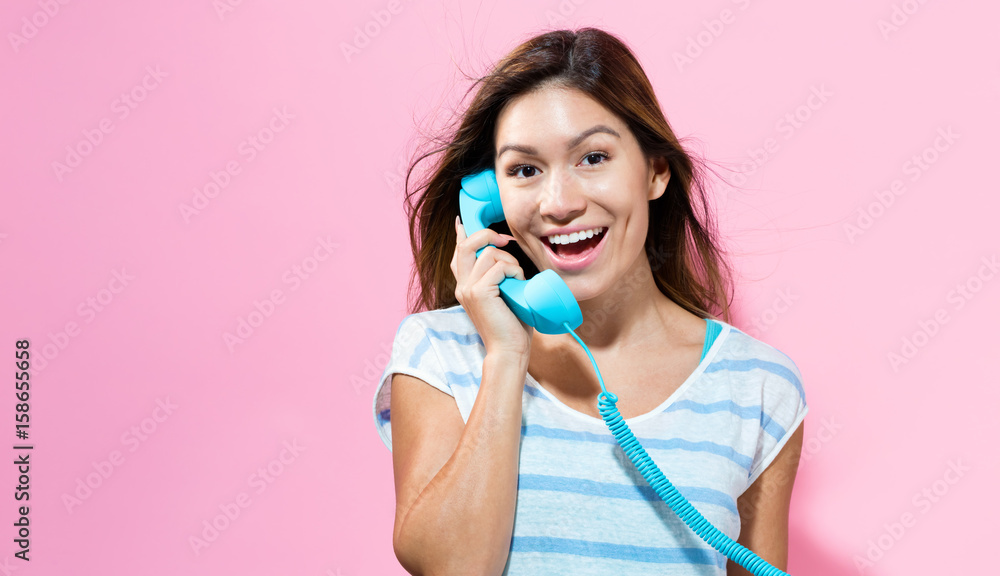 年轻女人用老式电话交谈