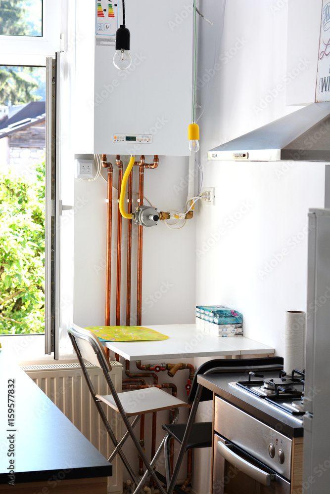 House interior – gas boiler with copper pipes in kitchen