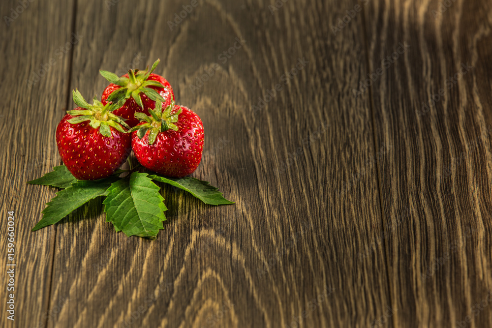 Ripe strawberries on wooden table. Fresh strawberries on wooden background. Strawberries on old wood