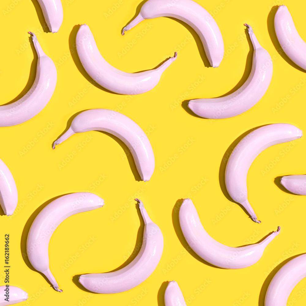 Series of painted pink bananas on a yellow background
