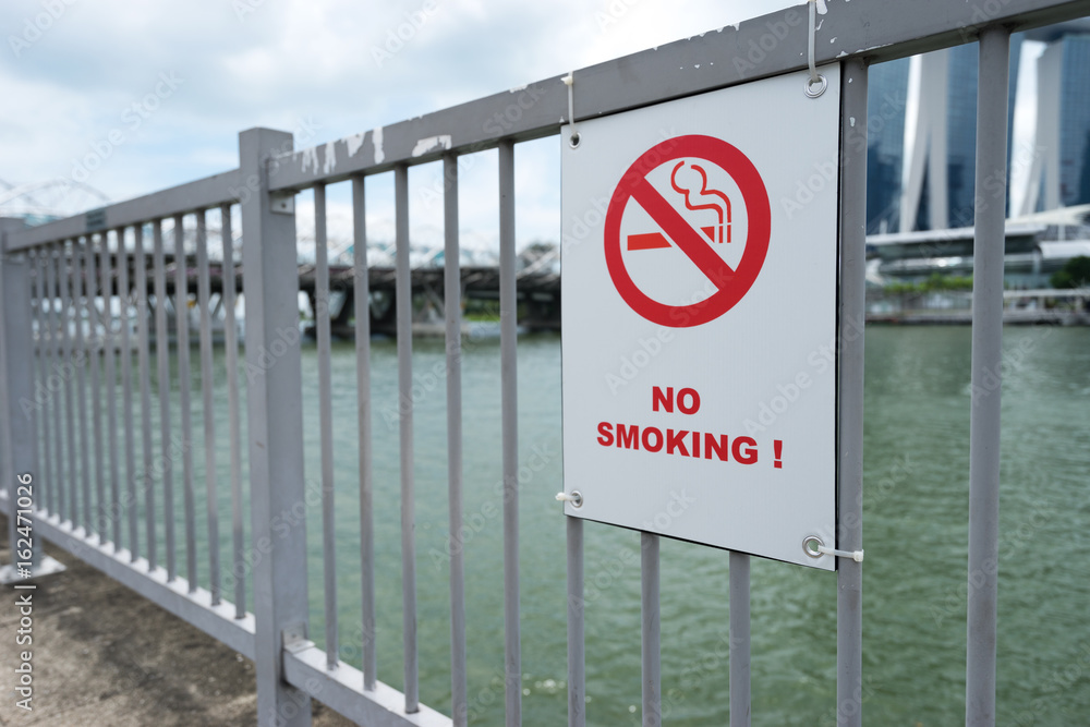 sign of no smoking on railing