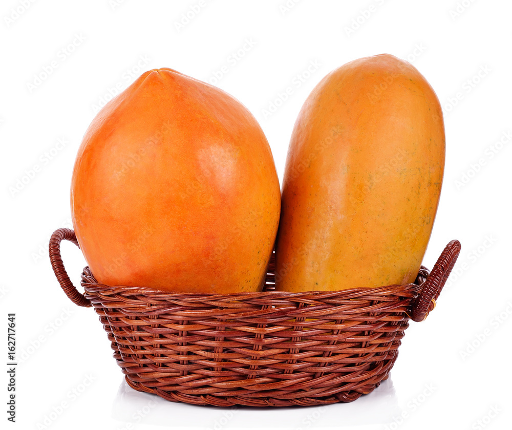 Two papaya in a basket on a white background