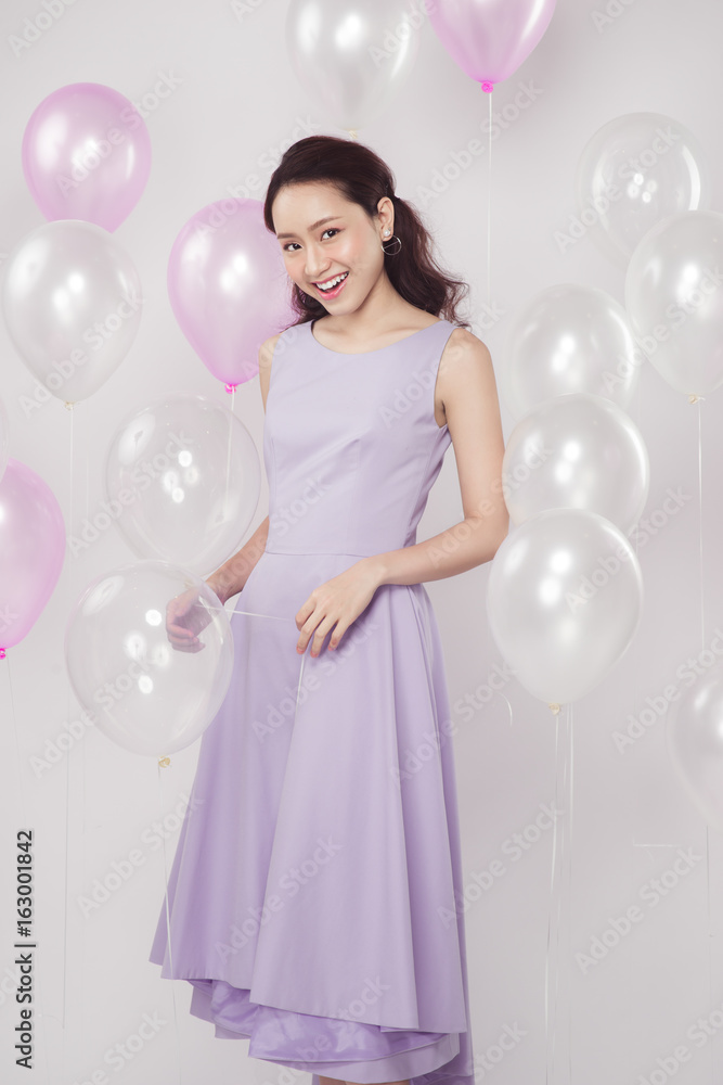 Asian pretty fashionable woman with pastel balloons