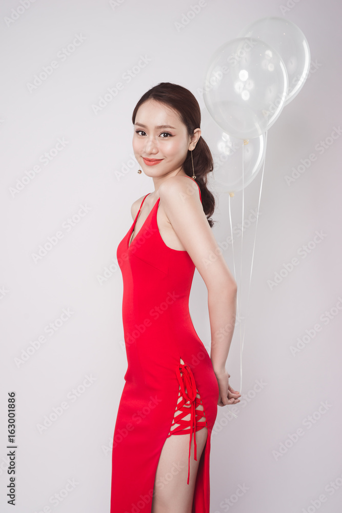 Asian beautiful woman in red dress with pastel balloons